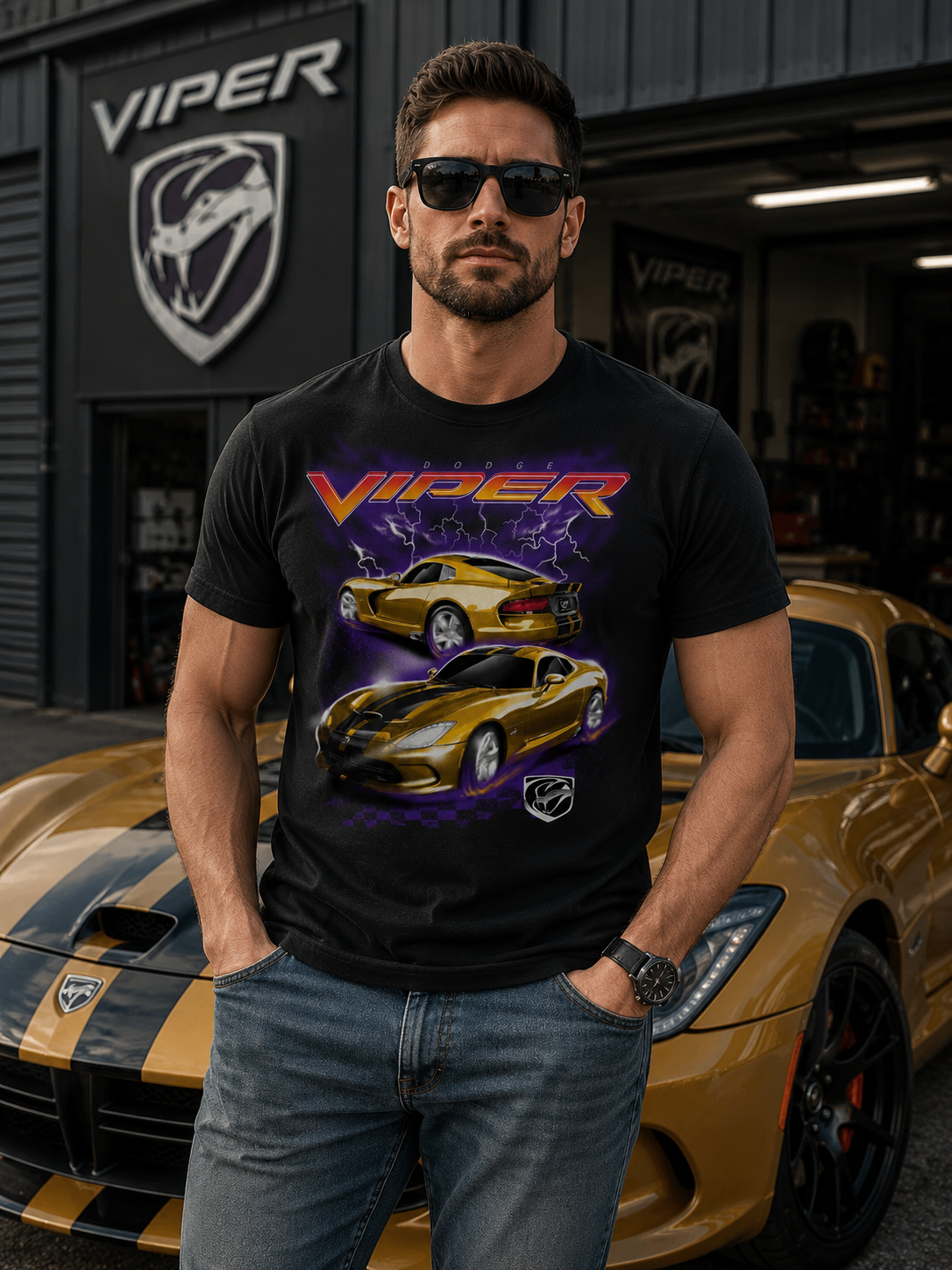 Male model wearing a Dodge Viper Storm graphic t-shirt standing in front of a gold Dodge Viper sports car outside a Viper performance garage with automotive lifestyle setting