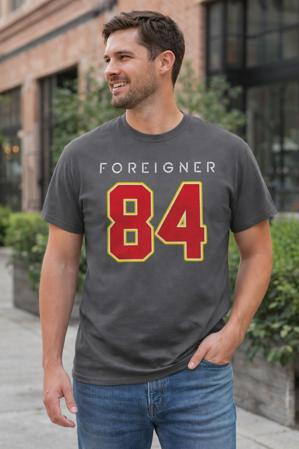Male model wearing Foreigner Agent Provocateur 84 t-shirt in charcoal with classic 1984 rock band design