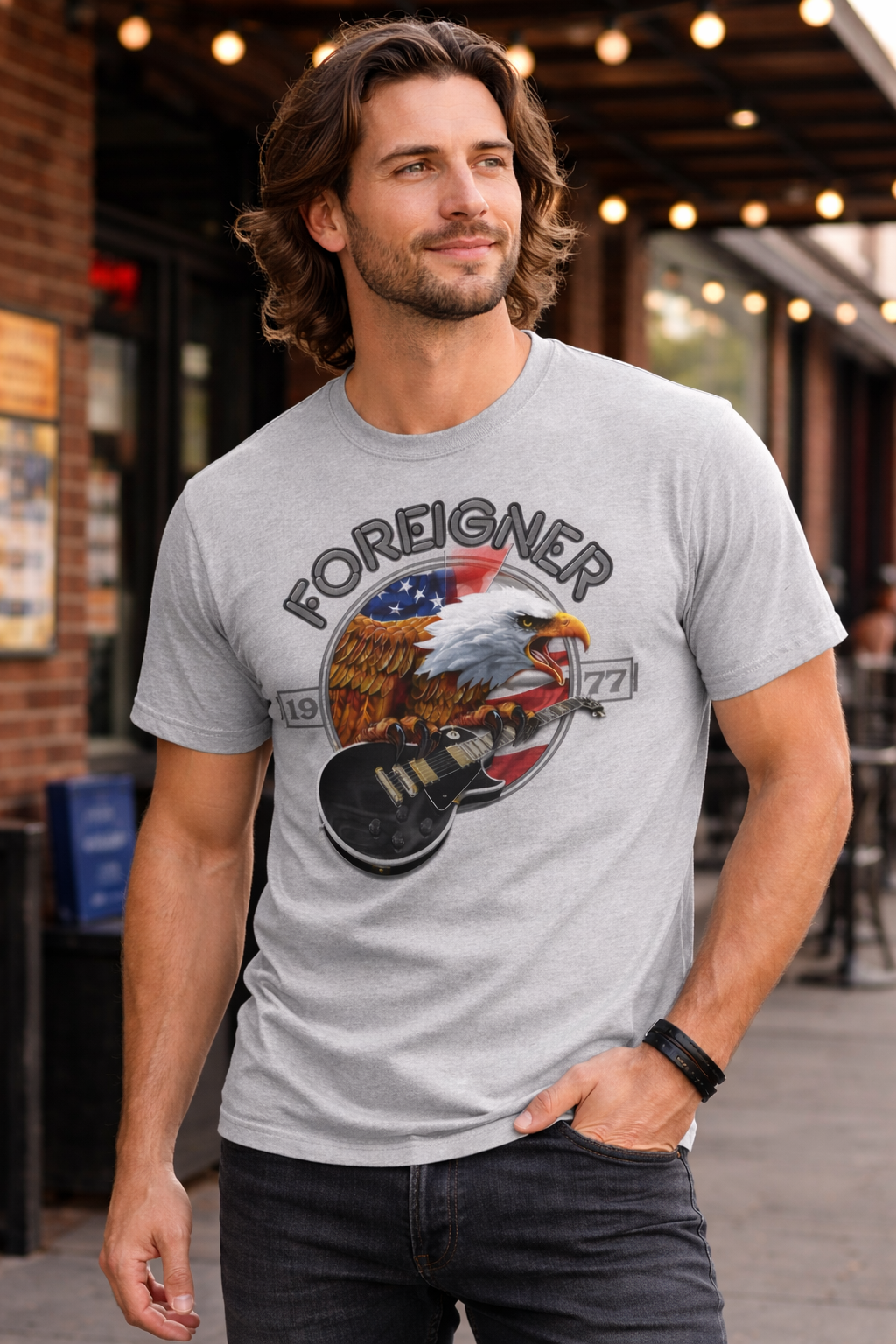 male model wearing Foreigner eagle 2022 vintage rock band t shirt grey guitar graphic outside music venue