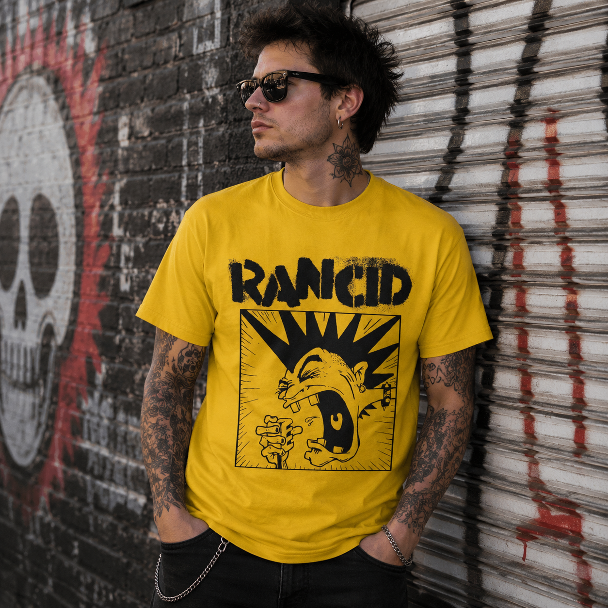 Male model wearing officially licensed Rancid mohawk punk band t-shirt in an urban graffiti alley with punk rock streetwear style.