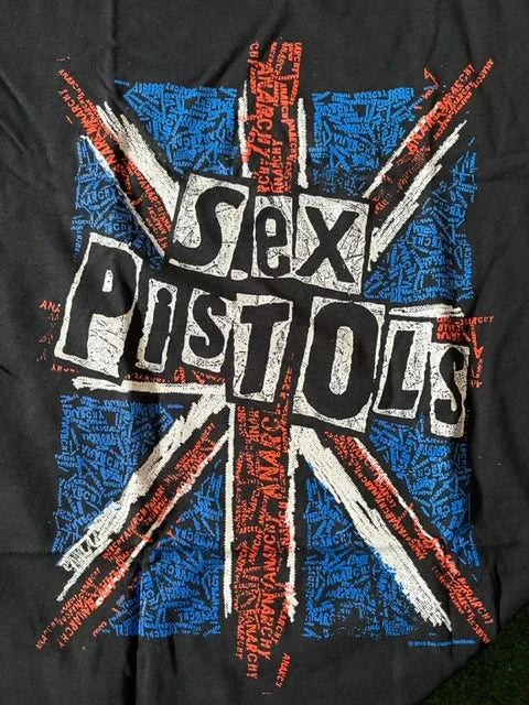 Close-up of the Sex Pistols logo over a distressed Union Jack flag graphic on an officially licensed black punk rock T-shirt