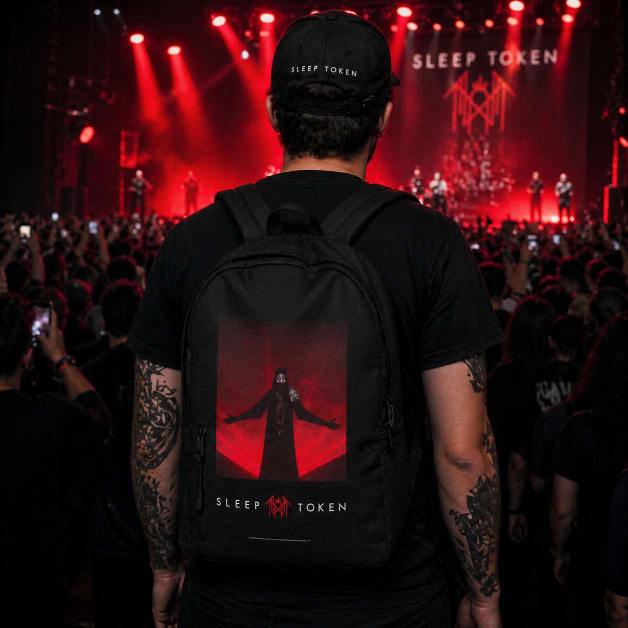 Male model wearing Sleep Token Red Light backpack at concert with crowd and stage lighting