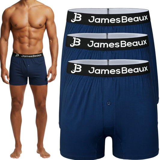 Man wearing navy blue boxer briefs with 'JamesBeaux' branding, alongside a stack of the same shorts.