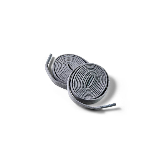 Two pairs of gray shoelaces on a white background