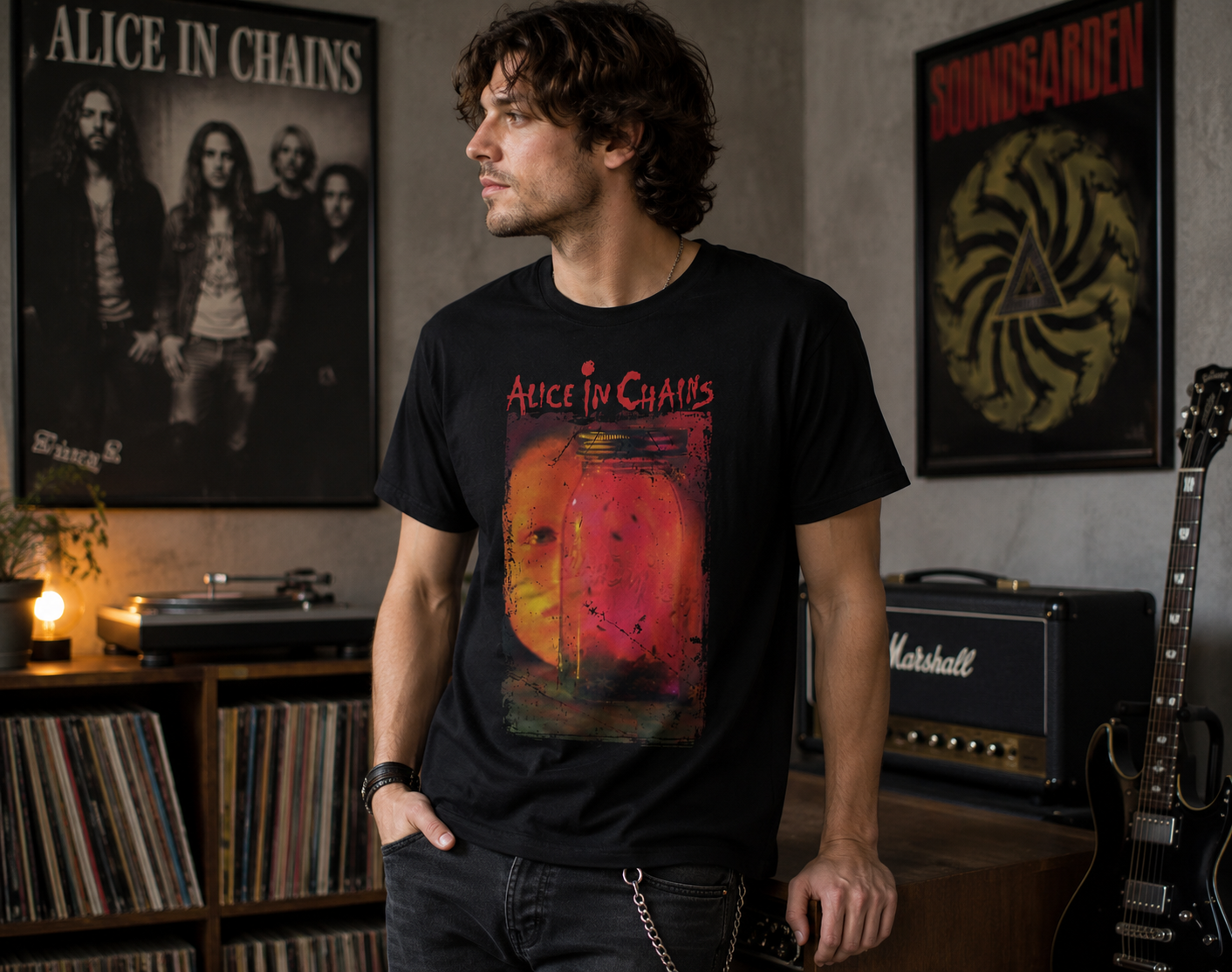 Male model wearing an Alice in Chains Jar of Flies t-shirt in a music studio featuring vinyl records, guitar gear, and grunge-inspired decor.