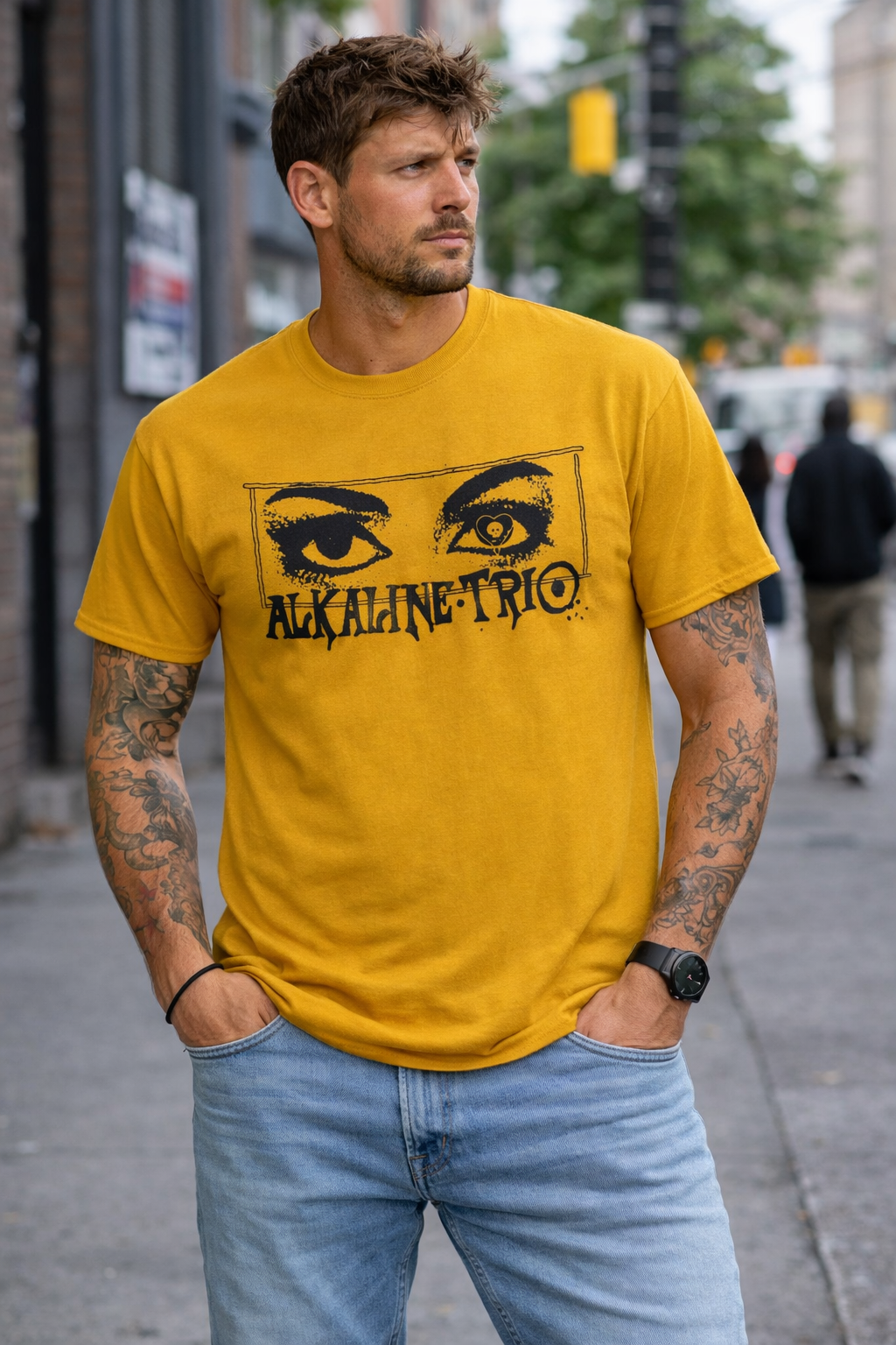 male model wearing Alkaline Trio Alkaline Stare gold t shirt with eye graphic streetwear style