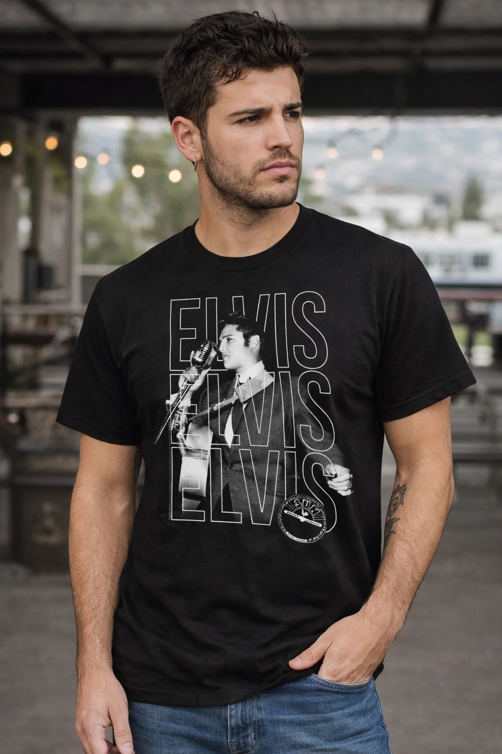 Male model wearing Elvis Presley black t shirt featuring vintage live performance graphic and Elvis text design officially licensed rock band merch