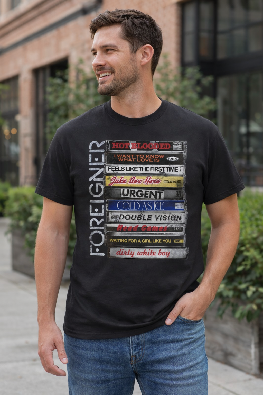 Male model wearing Foreigner Stacked Tapes t-shirt with retro cassette design classic rock band graphic tee