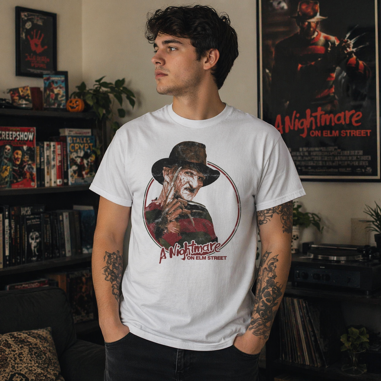 Male model wearing Freddy Krueger Nightmare on Elm Street t-shirt in horror themed room with Freddy poster and movie decor