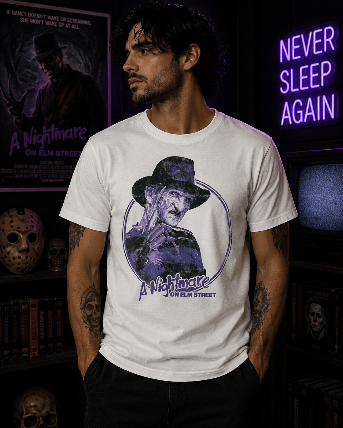 Male model wearing a white Freddy Krueger purple Nightmare on Elm Street t-shirt in a dark horror room with purple neon lighting.