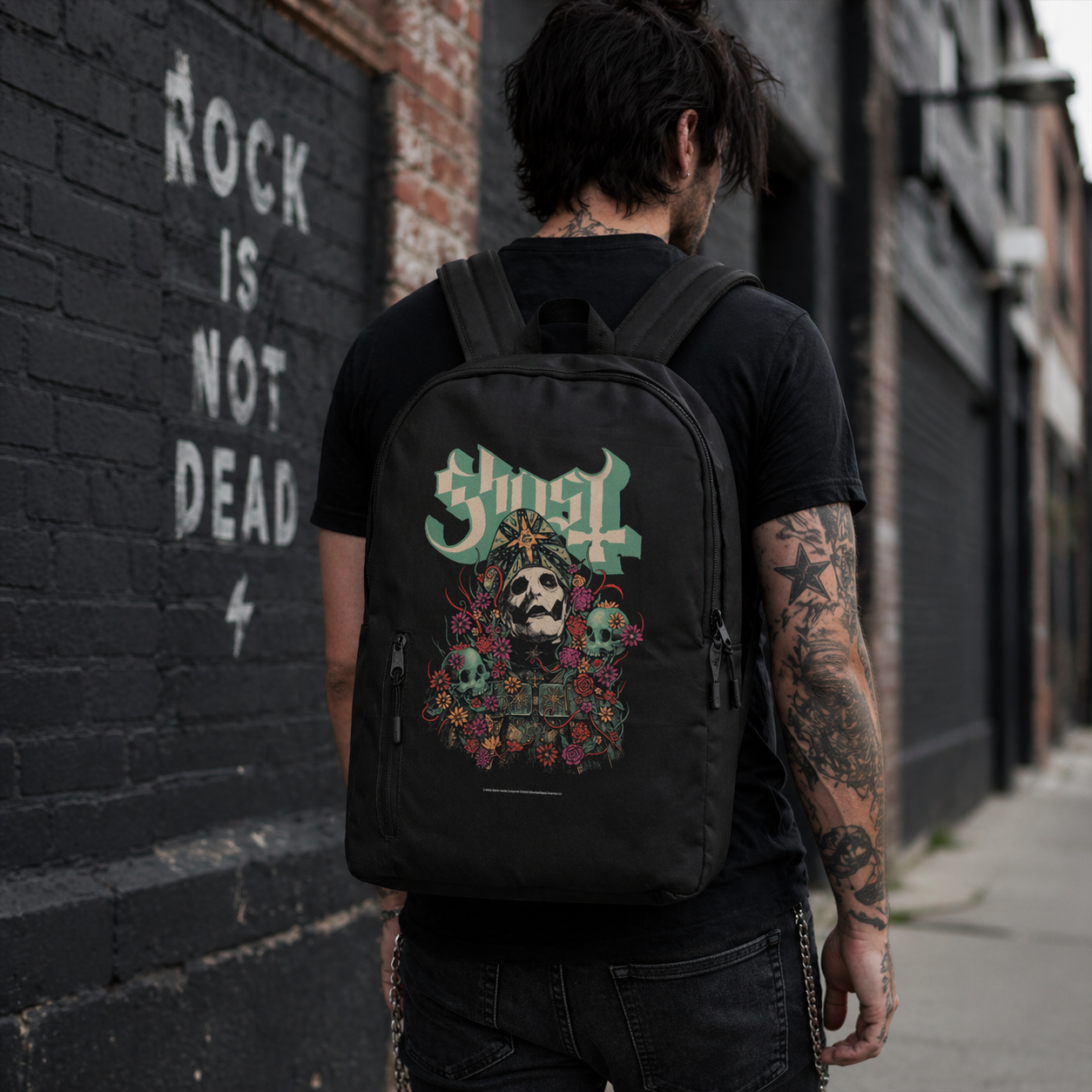 Male model wearing Ghost Bliss backpack with skull floral design in urban rock setting