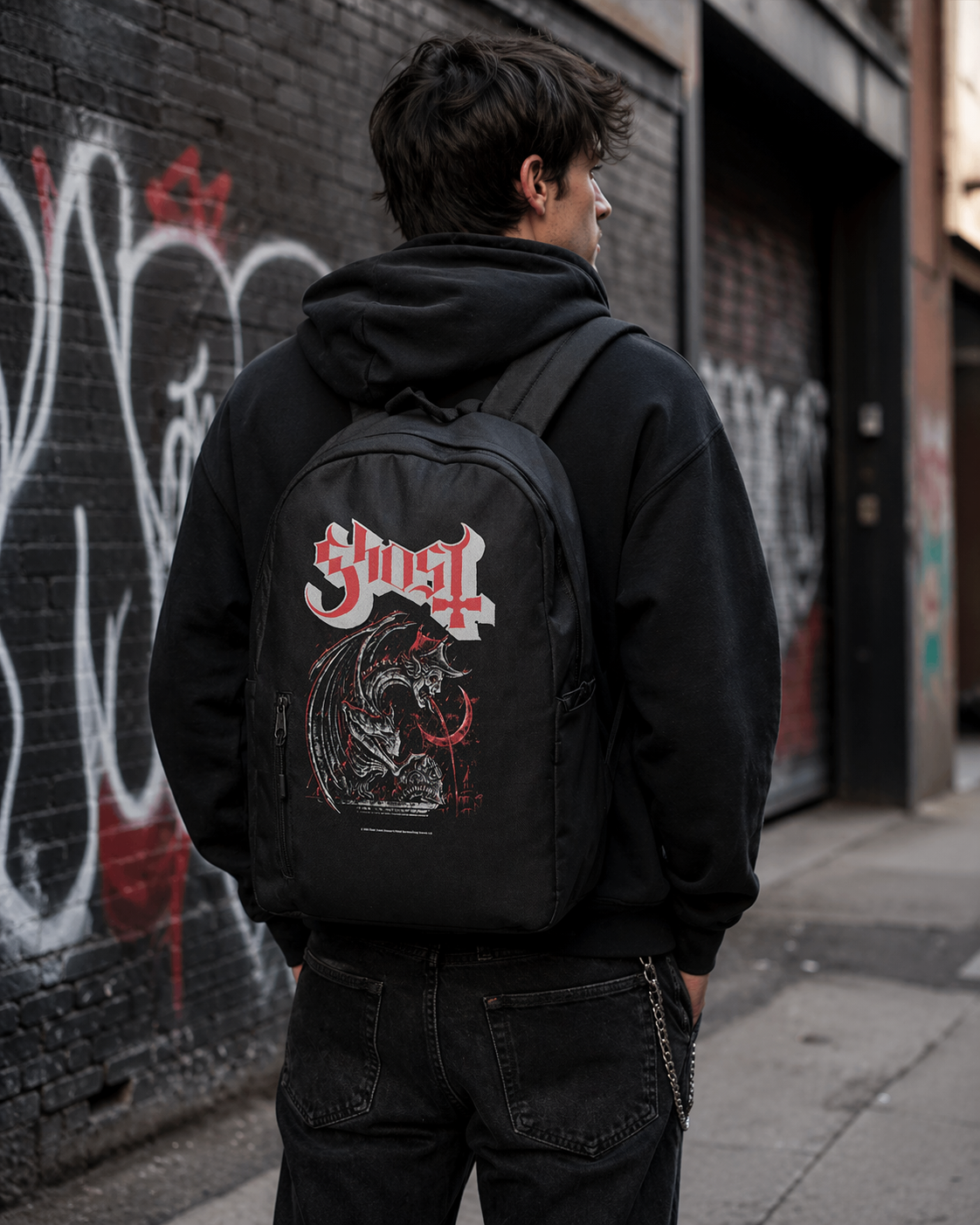 Male model wearing Ghost Devil backpack with gothic graphic in urban street setting