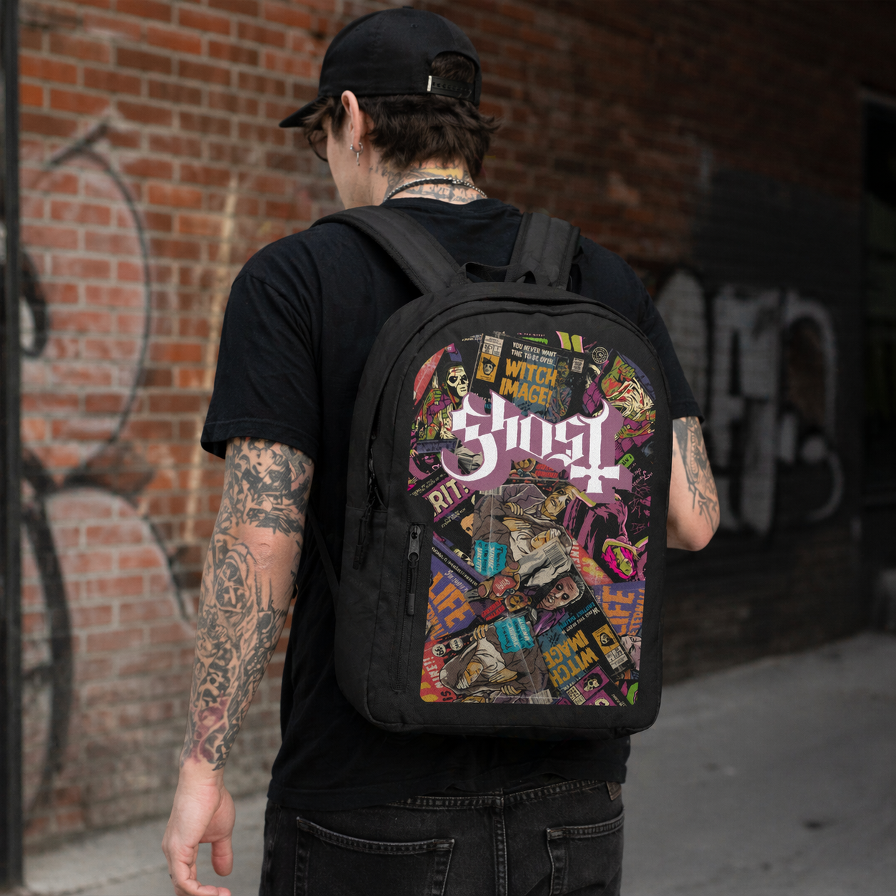 Male model wearing Ghost Magazines backpack with collage artwork in urban street setting