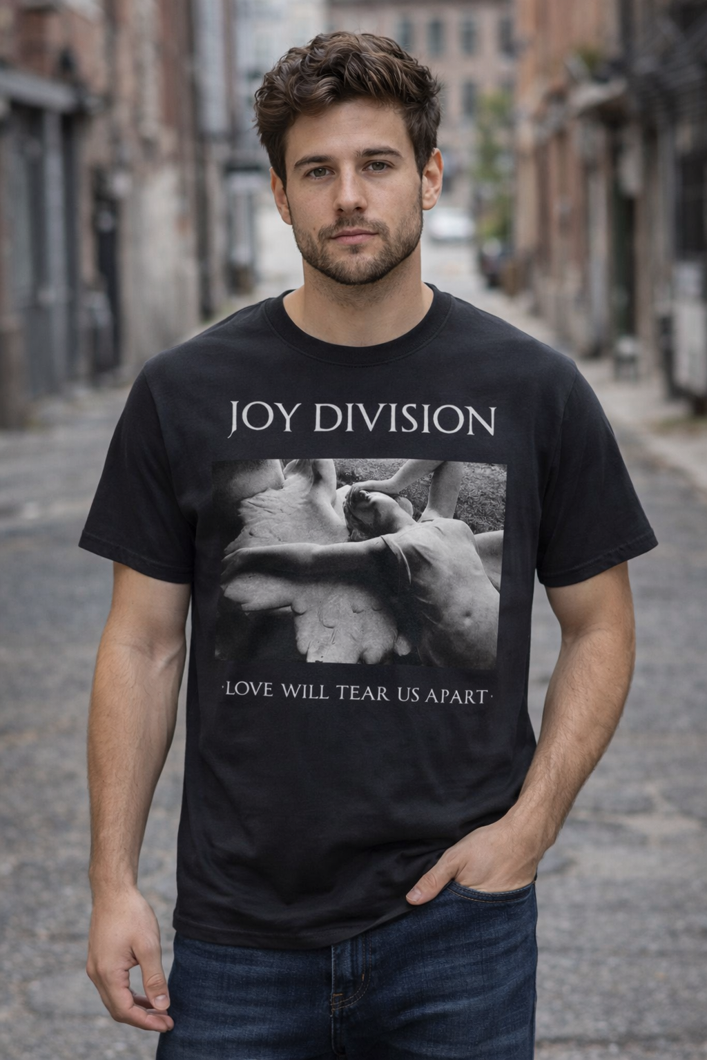 male model wearing Joy Division Love Will Tear Us Apart black t-shirt in urban street setting