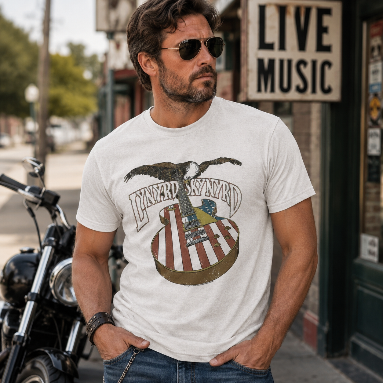 Male model wearing a Lynyrd Skynyrd eagle guitar t-shirt with American flag artwork and vintage Southern rock style