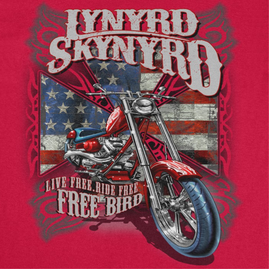 Close-up of Lynyrd Skynyrd Free Bird red t-shirt artwork featuring motorcycle graphic, American flag background, and distressed Southern rock design