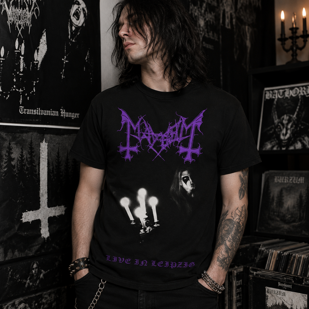 Male model wearing officially licensed Mayhem Live in Leipzig black metal band t-shirt in a dark underground metal room with black metal decor and candlelight atmosphere.