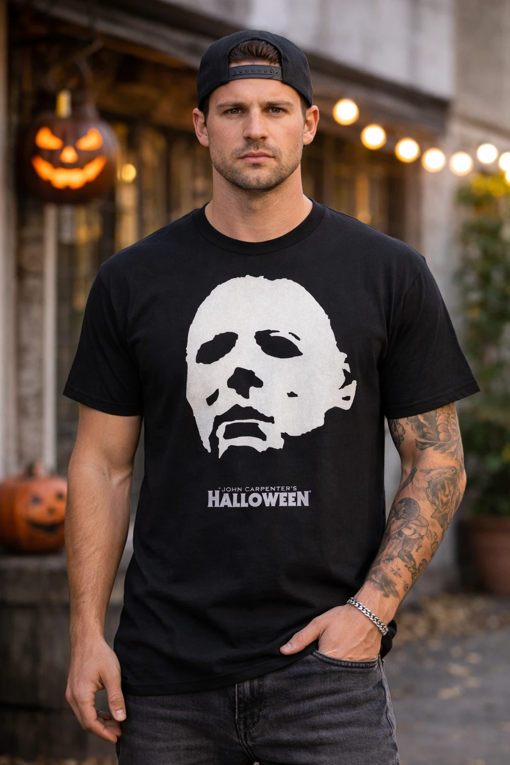 Male model facing forward wearing Michael Myers Halloween mask t shirt with horror movie graphic in outdoor setting