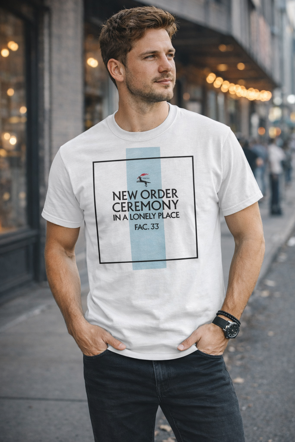 Male model wearing New Order Ceremony In A Lonely Place FAC 33 white t-shirt styled with jeans in urban street setting