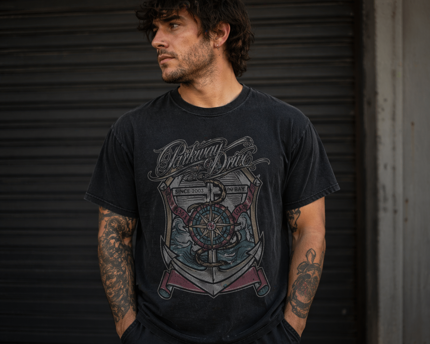 male model wearing Parkway Drive Byron Bay 2003 black band t shirt in urban setting metalcore merch