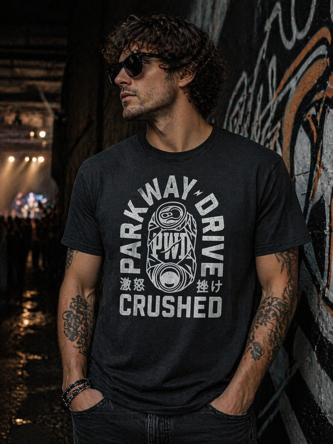 male model wearing Parkway Drive crushed can black t shirt in dark urban concert setting metalcore band merch