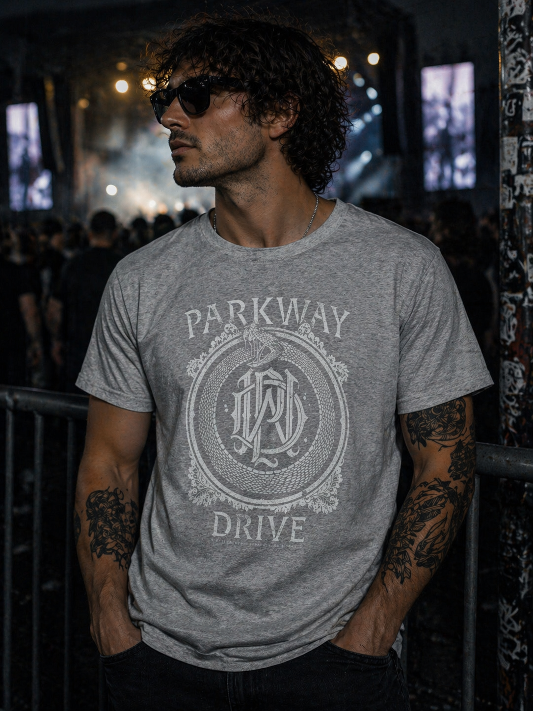 male model wearing Parkway Drive grey snake monogram t shirt at night concert setting metalcore band merch lifestyle