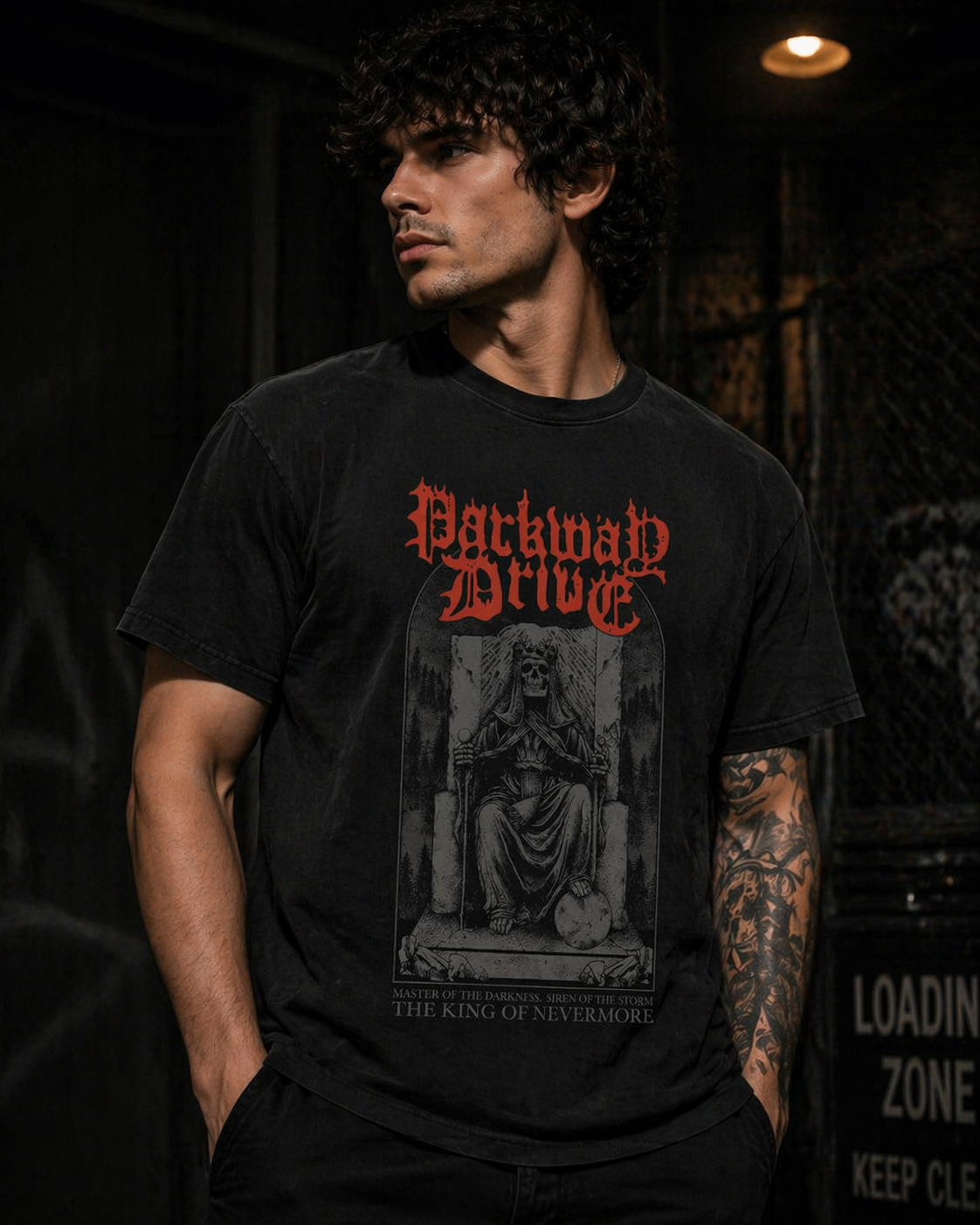 male model wearing Parkway Drive King of Nevermore t shirt with skull throne design in dark streetwear setting metalcore band merch