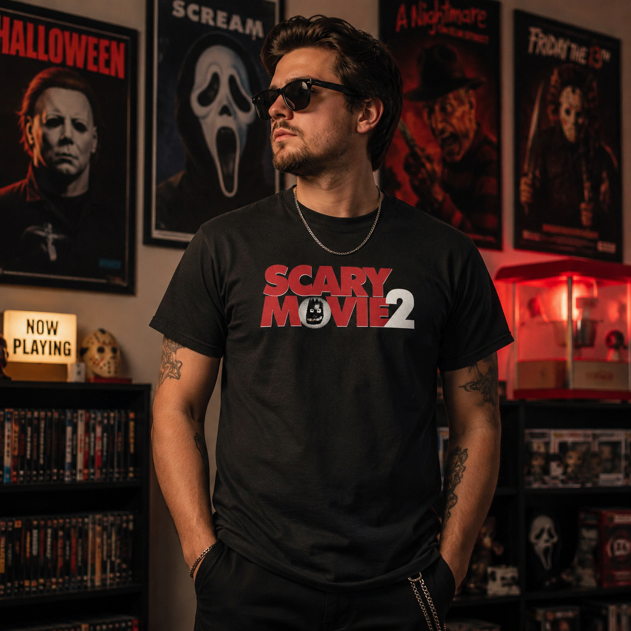 Male model wearing Scary Movie 2 Logo Black T-Shirt in a horror movie room with red lighting