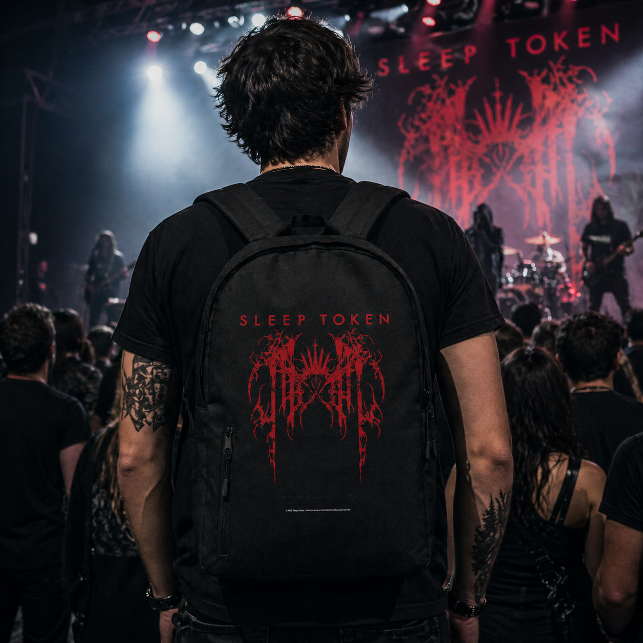 Male model wearing Sleep Token grunge logo backpack at concert with crowd and stage lights metal band merch lifestyle image