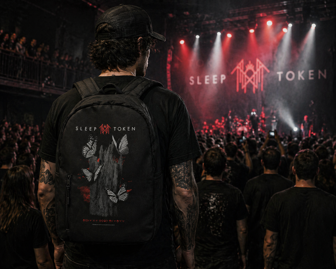 male model wearing Sleep Token Butterflies backpack at concert red black band merch