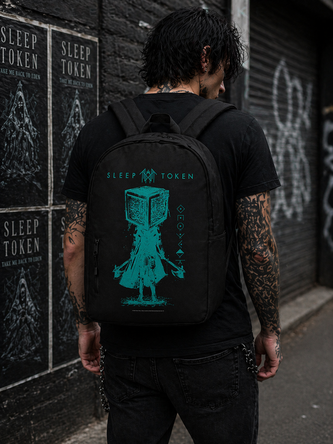 Male model wearing Sleep Token Granite backpack with teal graphic design in urban street setting