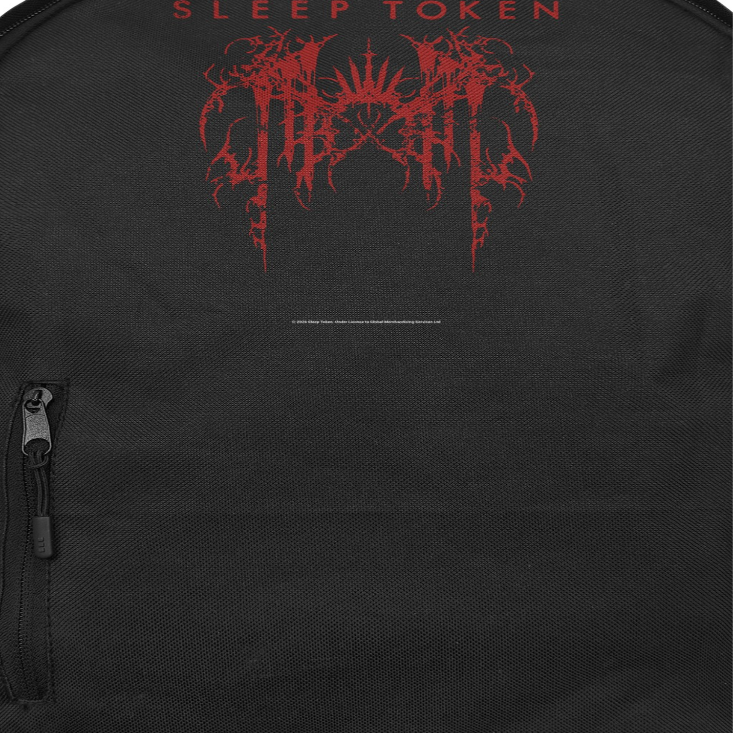Close-up of Sleep Token grunge logo backpack with red minimalist design on black official band merch bag