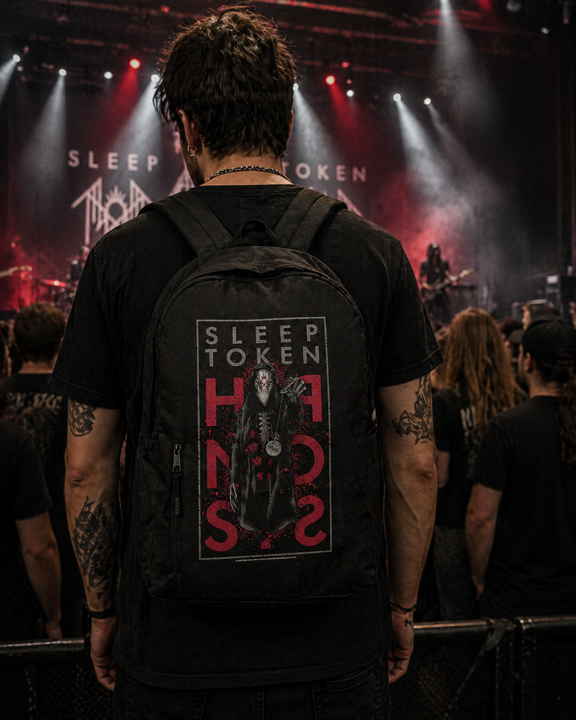 male model wearing Sleep Token Hypnosis backpack at concert red graphic band merch