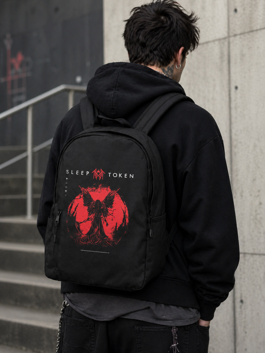 male model wearing Sleep Token TMBTE backpack red symbol urban streetwear band merch