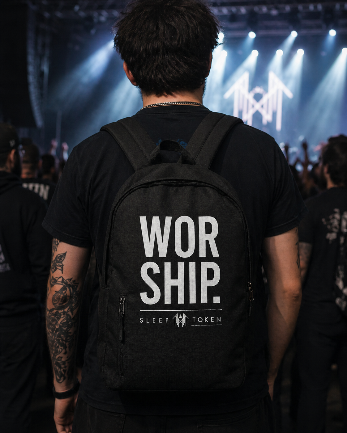 Male model wearing Sleep Token Worship backpack at concert with crowd and stage lights official band merch lifestyle image