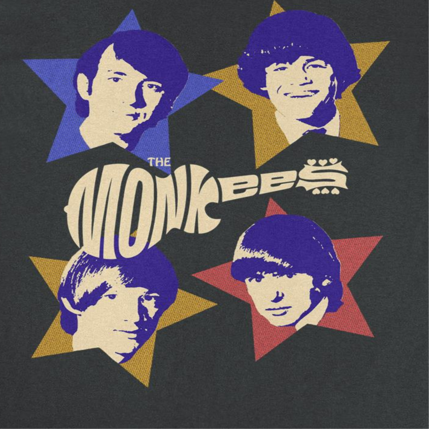 Close-up of The Monkees Stars band t-shirt featuring vintage-inspired colorful star graphics and retro 1960s pop rock artwork on a black tee