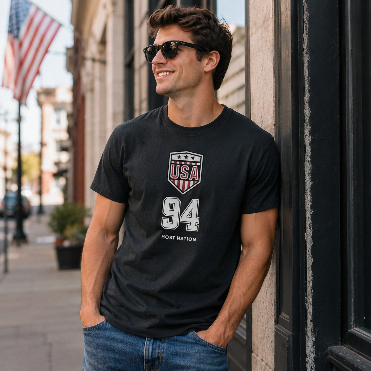 Male model wearing USA logo black retro soccer t-shirt with shield crest artwork, number 94 detail, and host nation design